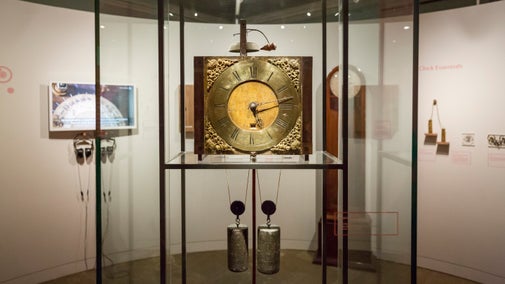 An 18th century wooden clock made by John Harrison's in a glass cabinet at Nostell